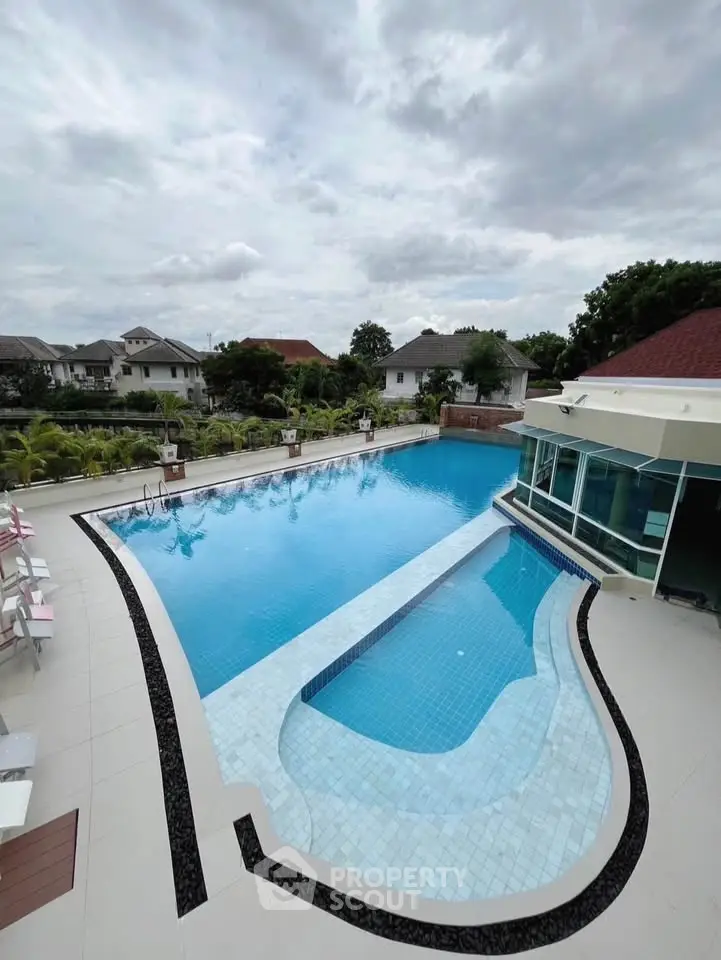 Luxurious residential pool with modern design and lush surroundings, perfect for relaxation and leisure.