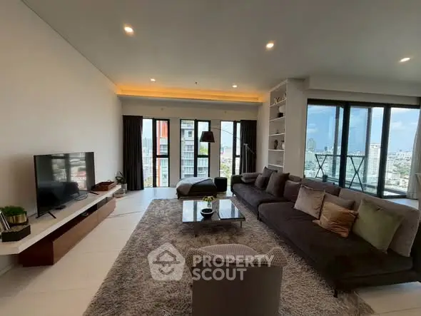 Spacious modern living room with city view and large balcony access