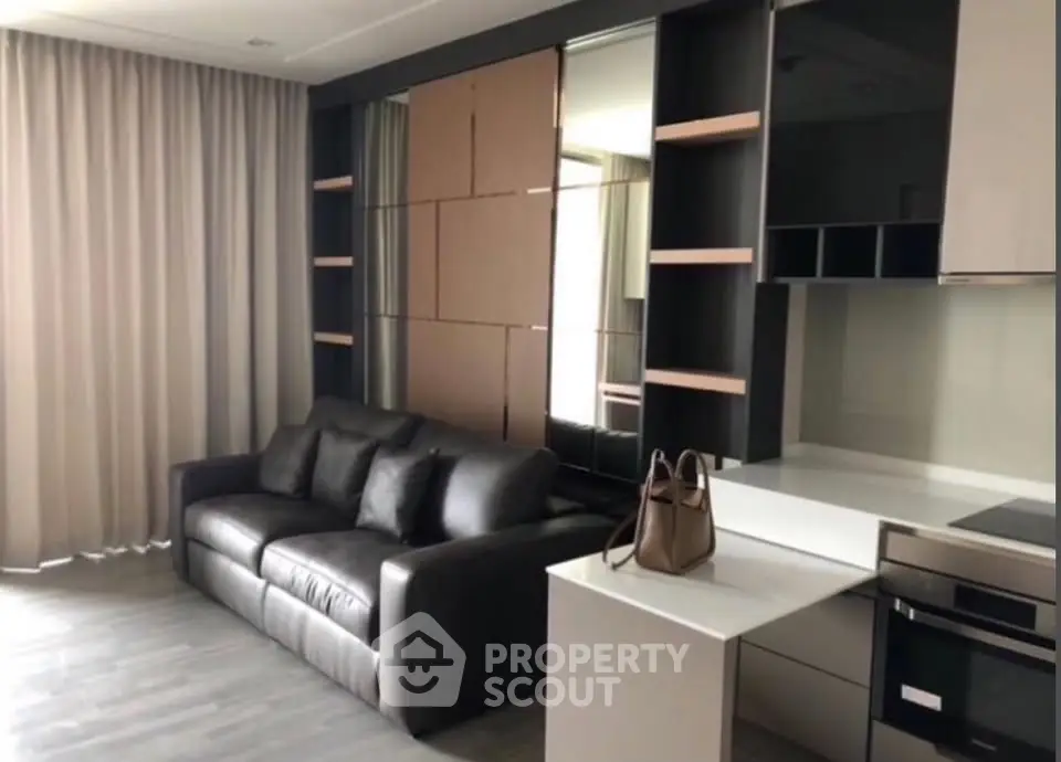 Modern living room with sleek furniture and integrated kitchen area