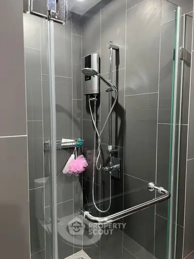 Modern bathroom with sleek shower design and glass door enclosure.