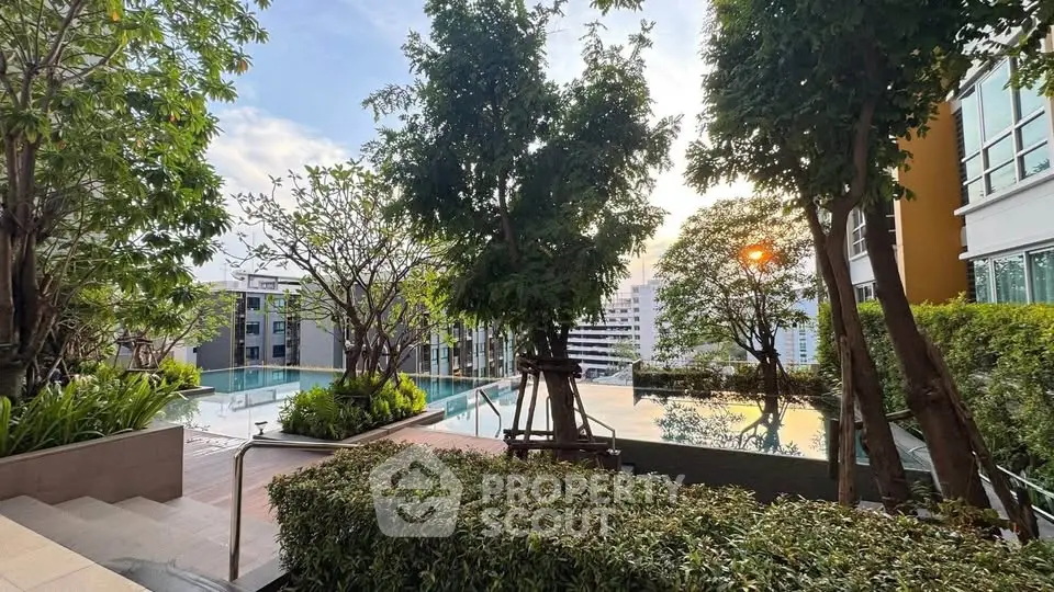 Luxurious rooftop pool with lush greenery and stunning city views at sunset.