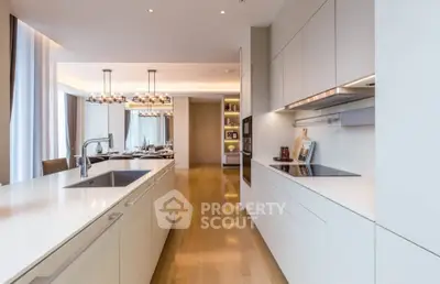 Luxurious modern kitchen with sleek cabinetry and spacious dining area, perfect for entertaining.