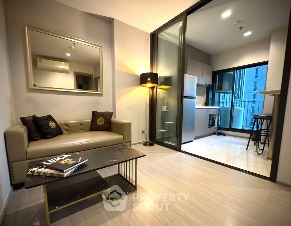 Modern living room with open kitchen and stylish decor in a contemporary apartment.