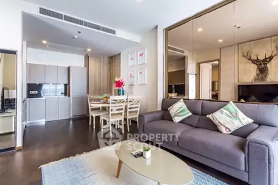 Modern living room with stylish decor and open kitchen layout in a contemporary apartment.