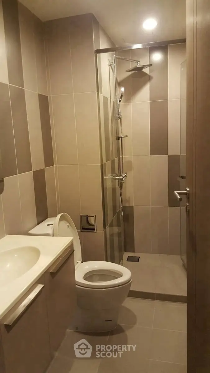 Modern bathroom with sleek design and walk-in shower in a contemporary apartment.