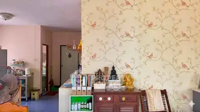 Charming living space with floral wallpaper and decorative accents.