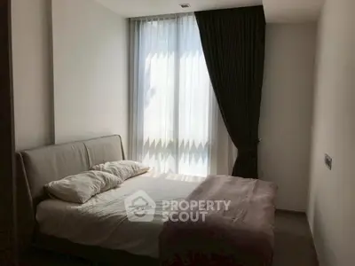 Cozy bedroom with soft lighting and elegant curtains, perfect for relaxation.