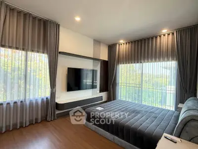 Spacious modern bedroom with large windows and stylish decor