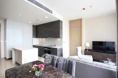 Modern open-plan living room and kitchen with sleek design and natural light