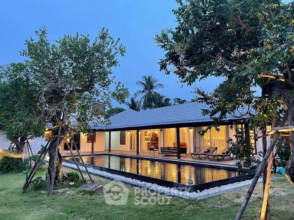 Luxurious villa with private pool and lush garden at twilight