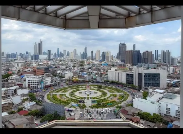 Stunning cityscape view from a high-rise building showcasing urban skyline and circular park.