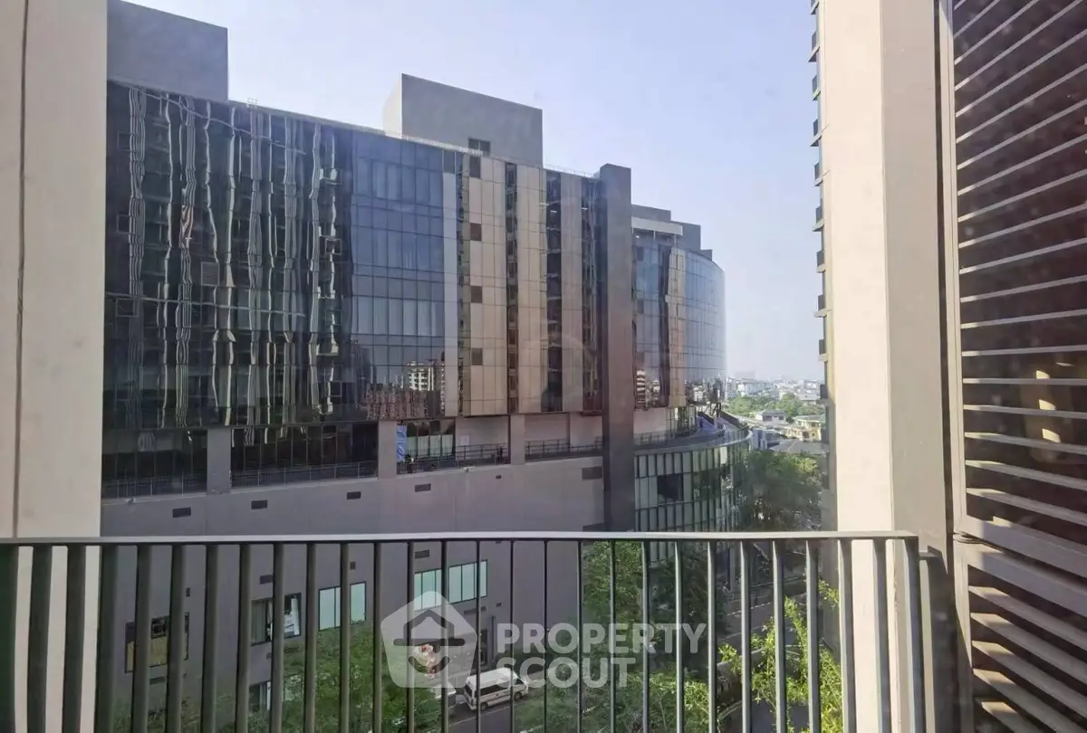 Modern urban view from balcony with glass facade building