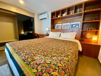 Cozy bedroom with vibrant bedding, built-in shelves, and air conditioning for ultimate comfort.