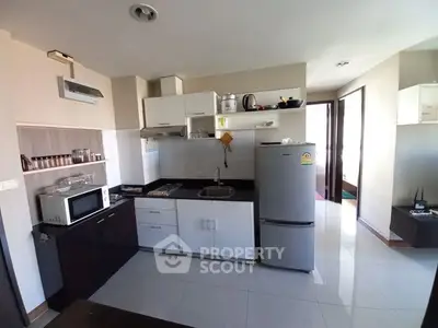 Spacious kitchen with modern appliances, ample cabinetry, and sleek countertops, perfect for culinary enthusiasts looking to create gourmet meals at home.