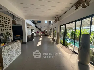 Spacious modern living area with pool view and stylish decor