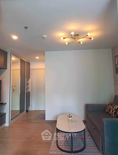 Modern living room with stylish lighting and cozy sofa in a contemporary apartment.