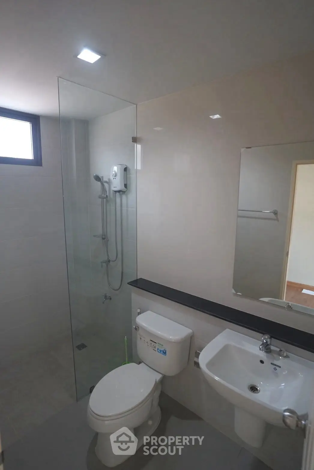 Modern bathroom with glass shower enclosure and sleek fixtures