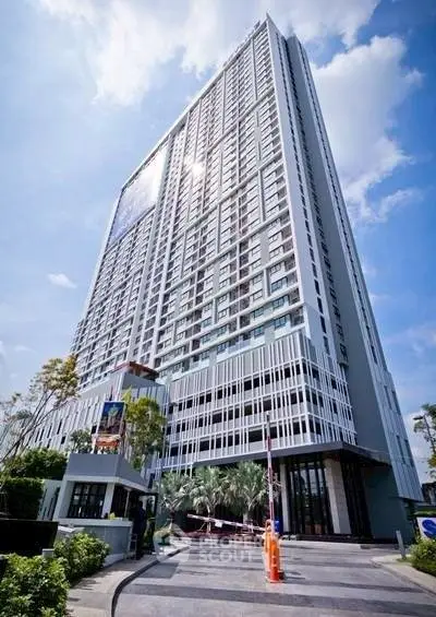 Stunning high-rise building with modern architecture and lush landscaping, perfect for urban living.
