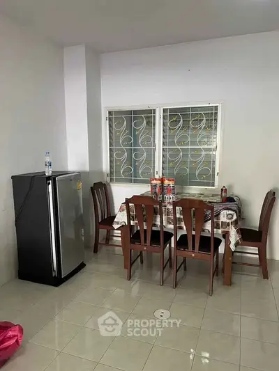 Cozy dining area with modern fridge and elegant wooden table set