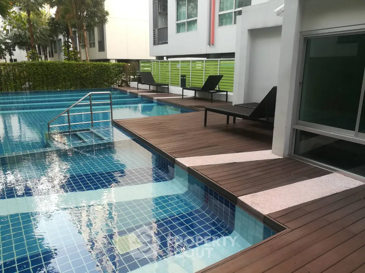 Luxurious poolside area with modern design and relaxing lounge chairs