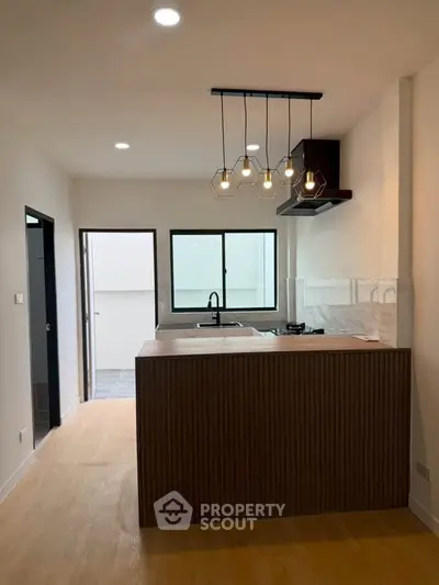 Modern kitchen with open layout and stylish lighting in a contemporary apartment.