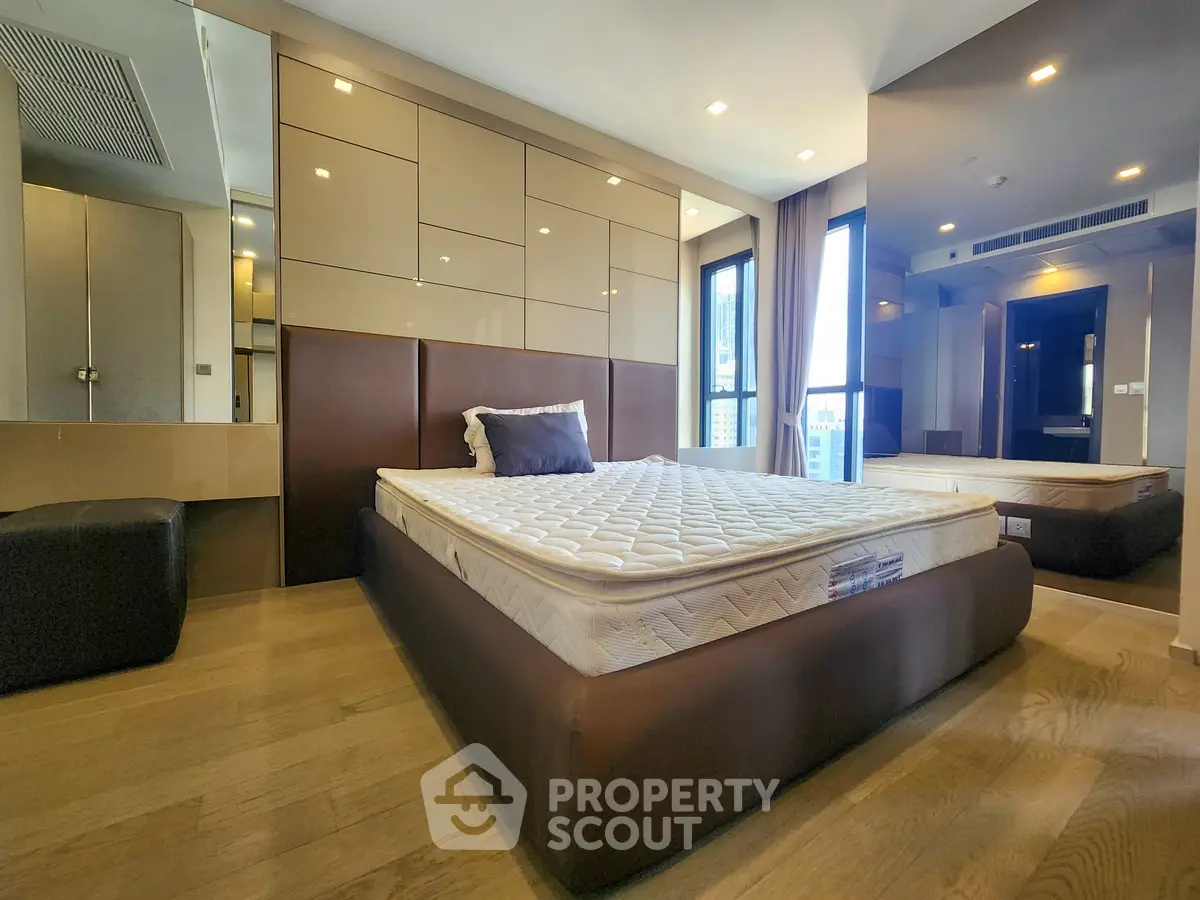 Spacious modern bedroom with large windows and elegant decor