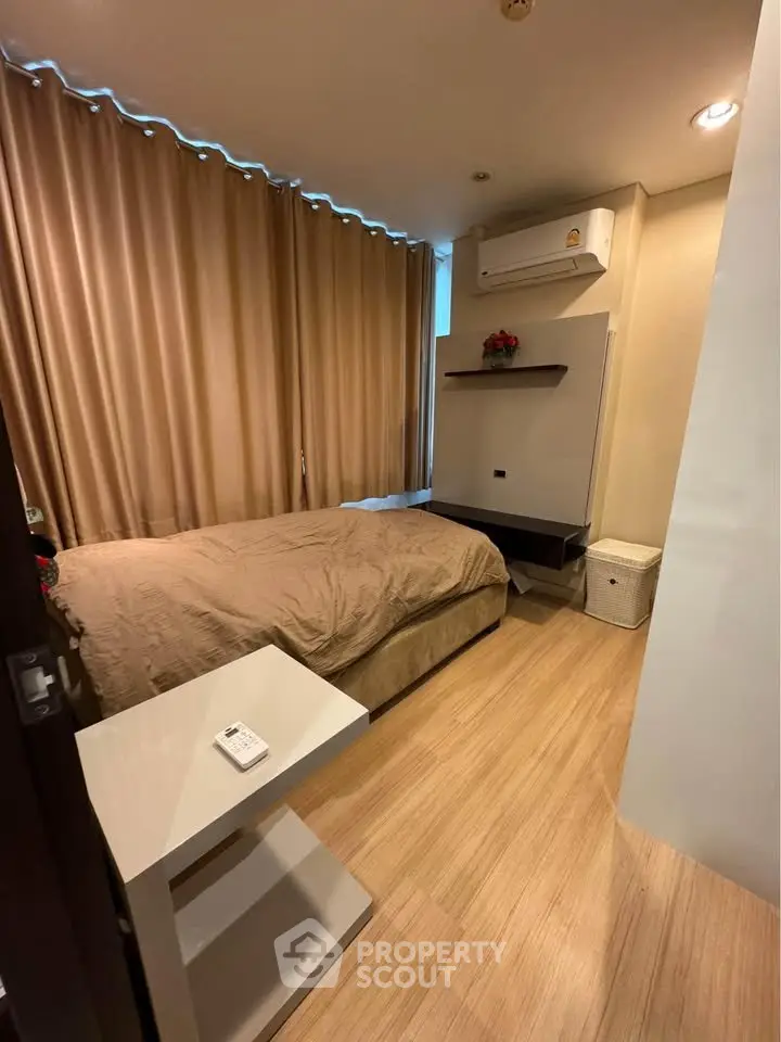 Cozy bedroom with modern decor and air conditioning in a stylish apartment.