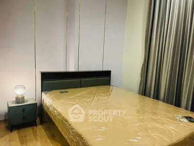 Modern bedroom with sleek design and cozy ambiance, featuring a stylish bed and elegant nightstand.