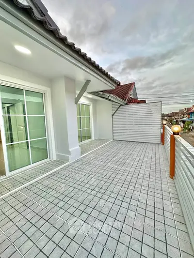 Spacious tiled balcony with modern railing and sliding glass doors, perfect for outdoor relaxation.