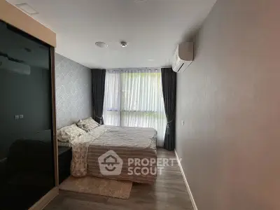 Cozy bedroom with modern decor and large window for natural light