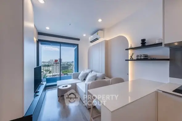Modern living room with city view, sleek furniture, and ambient lighting in a high-rise apartment.