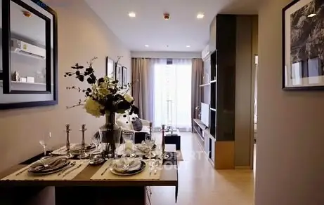 Stylish open-plan living room with elegant dining area and modern decor.