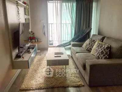Cozy living room with modern decor and balcony view, perfect for relaxation and entertainment.