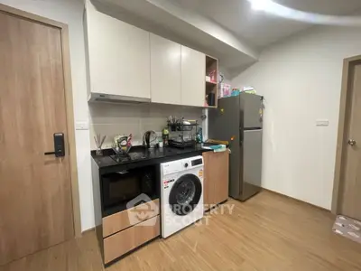 Modern kitchen with washing machine and fridge in compact layout
