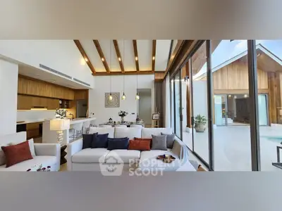 Luxurious open-plan living room with high ceilings and pool view