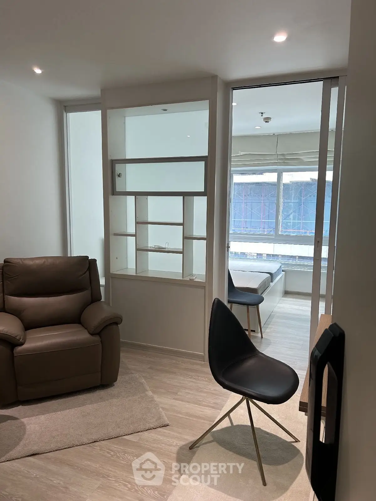 Modern living room with sleek furniture and large windows for natural light.