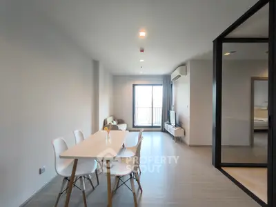 Modern open-plan living and dining area with sleek furniture and natural light.