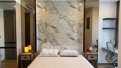Luxurious bedroom with marble accent wall and modern decor