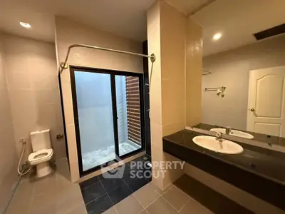 Spacious modern bathroom with dual sinks and large shower area