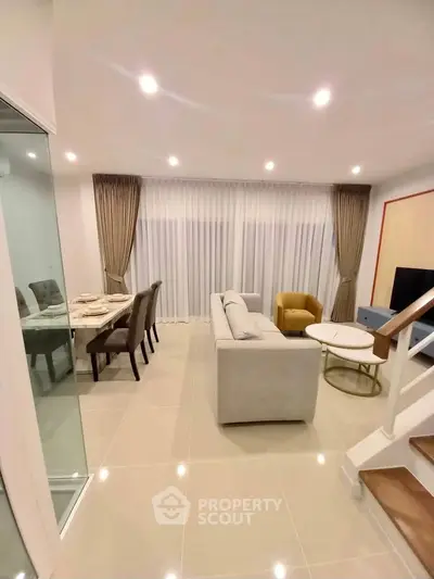Modern living room with elegant dining area and cozy seating
