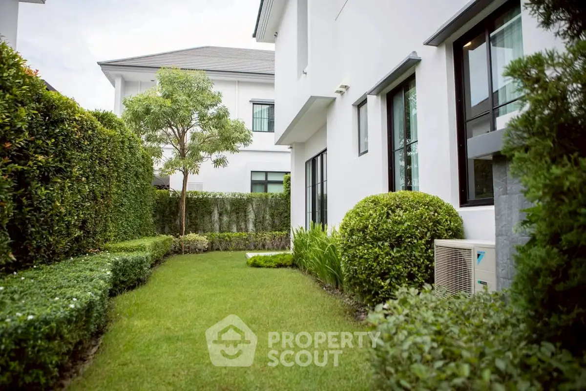 Charming garden view of modern white house with lush greenery