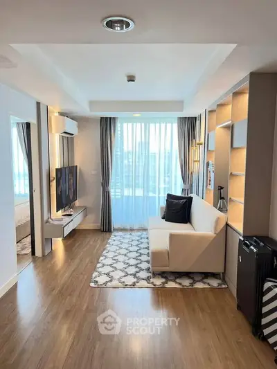 Modern living room with sleek design, large window, and stylish furniture in a bright apartment.