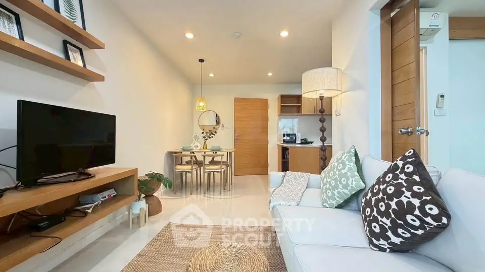 Modern living room with cozy decor and open layout, featuring a stylish dining area and contemporary furnishings.