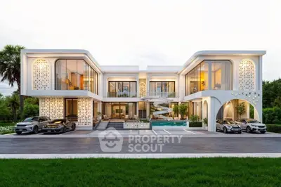 Luxurious modern mansion with sleek architecture, large windows, and elegant driveway, showcasing opulent living.