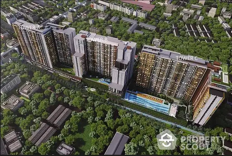 Aerial view of modern residential complex with three towers surrounded by lush greenery.