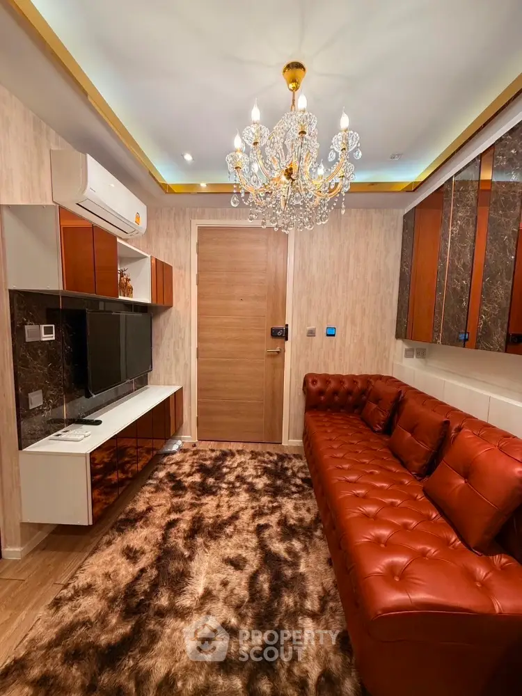 Luxurious living room with elegant chandelier and plush leather sofa