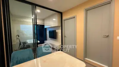 Modern apartment interior with glass partition and stylish furniture, ideal for urban living.