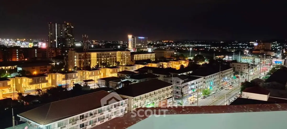 Stunning night cityscape view from a high-rise balcony showcasing vibrant urban lights and skyline.