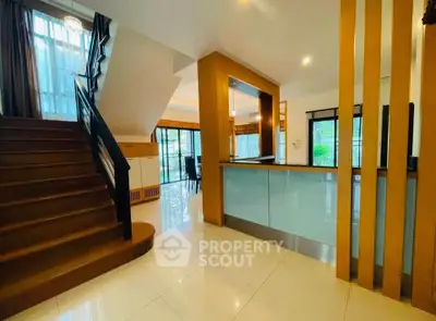 Spacious modern interior with elegant staircase and open layout kitchen, perfect for family living.