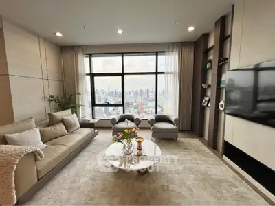 Luxurious living room with stunning city view, modern decor, and elegant furnishings.